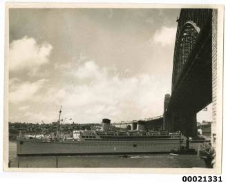 TSS MONTEREY II carrying the aircraft 'The Spirit of Fun' underneath the Sydney Harbour Bridge