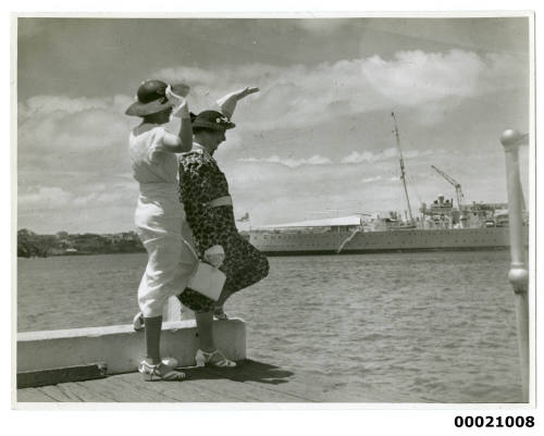 Women waving to HMAS AUSTRALIA II or HMAS CANBERRA I