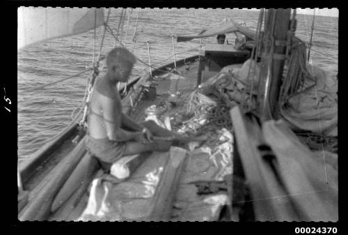 Richard Nossiter on deck of SIRUS surrounded by canvas, wood, and ropes