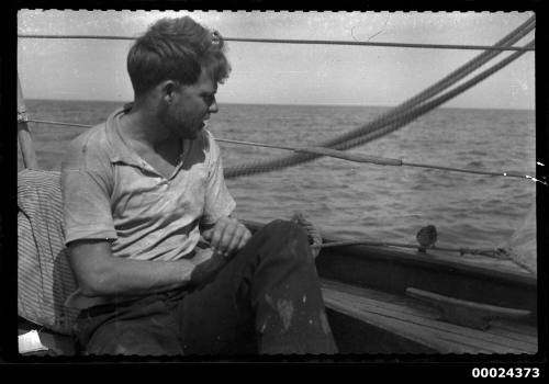 Harold Nossiter Jnr watches a small bird on yacht SIRIUS