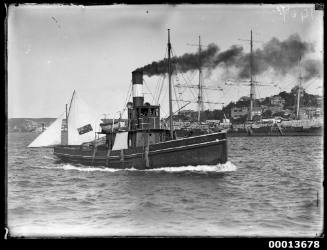 The tugboat GAMECOCK steaming past the 18-foot skiff KISMET Sydney Harbour