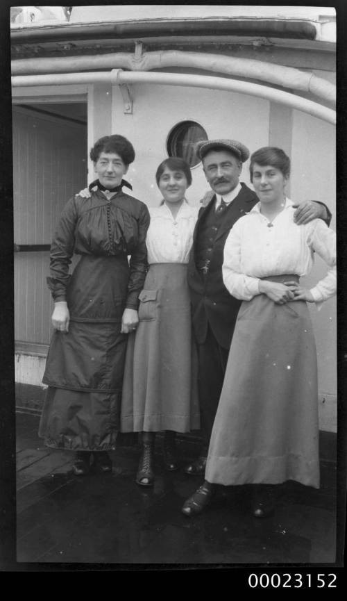 Captain E R Sterling with three women on board a ship