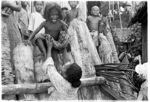 View of a child being lifted down from platform