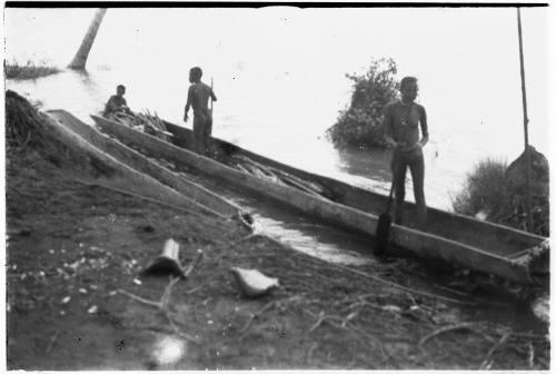 View of men in a dugout canoe