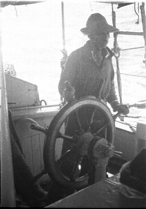 View of a man at a ship's helm