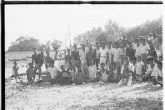 View of Oskar Speck with group of people on the beach