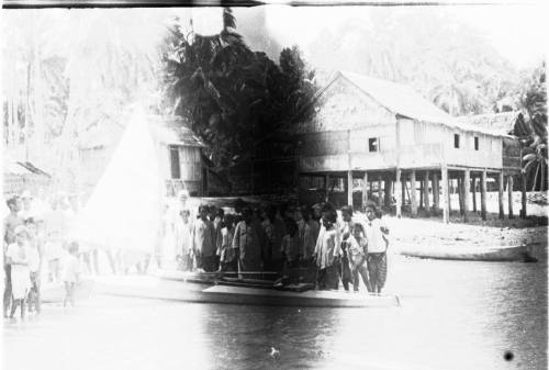 View of a crowd standing in the water next to SUNNSCHIEN 