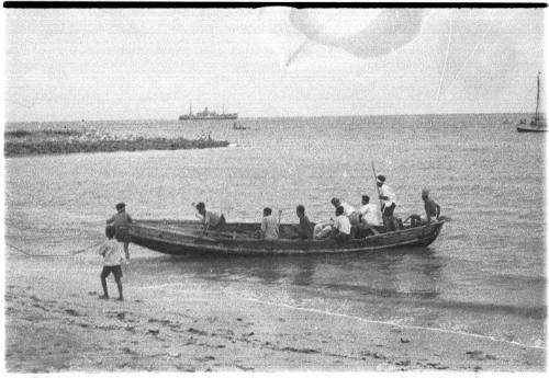 View of a long boat coming into the shore 