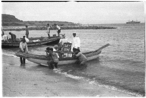 View of two row boats coming ashore