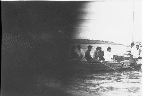 Partial view of a row boat coming ashore