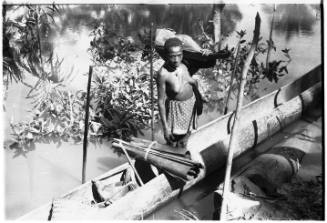 View of a woman in dugout canoe