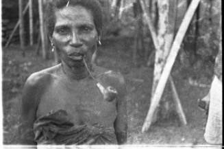 View of a woman smoking a pipe