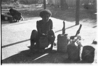 View of a man sitting next to buckets