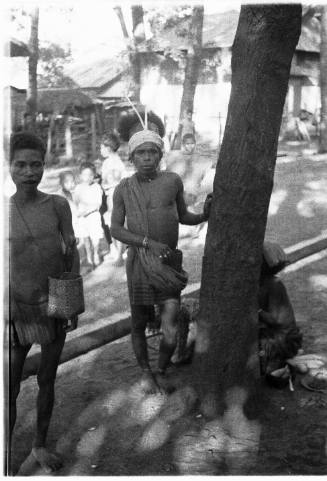 View of a  group of men next to a palm tree