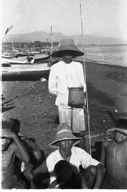 View of fishermen on beach with canoes 