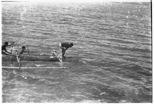 View of boys on an outrigger canoe