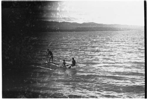 Partial view of boys on an outrigger canoe 