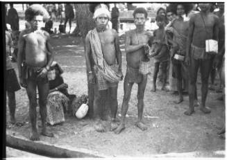 View of young men standing near tree