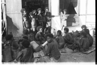 View of a small crowd gathered outside a house 