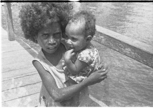 View of a child holding a baby