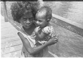 View of a child holding a baby