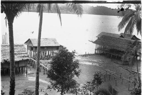 View of raised huts along the water's edge 