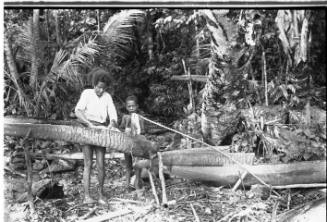 View of a woman and child making sago