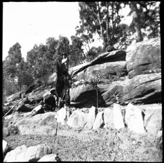 View of man standing on sandstone escarpment 