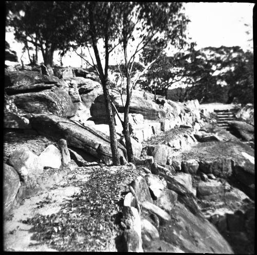 View of a rocky hill with sandstone retaining walls 