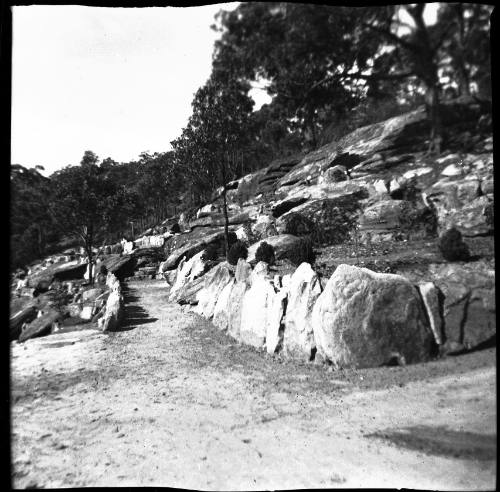 View of hillside with sandstone retaining walls 