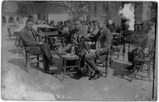 View of men seated at an outdoor café 