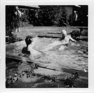 View of a couple in a backyard pool