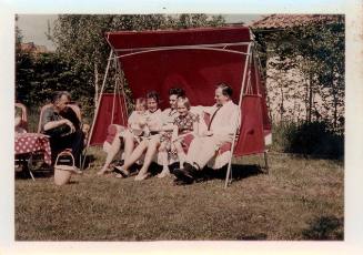 View of a family group seated in a swing chair 