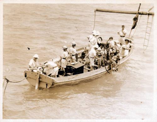 Silver gelatin photograph featuring group of sailors leaving their vessel in small craft