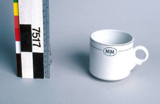 White ceramic cup with "MM" initials from McIlwraith McEacharn Ltd.