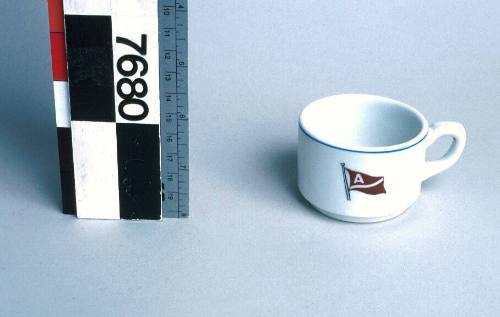 White ceramic coffee cup with houseflag, vessel and shipping line unknown.