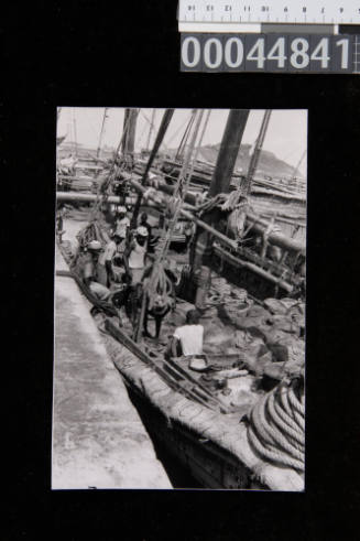 Crew on the deck of a large dhow at Ma'alla in Aden, Yemen