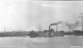 Steam cargo ship alongside wharf