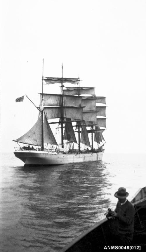 Four masted barque setting or reducing sail