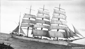 Four masted barque setting or reducing sail