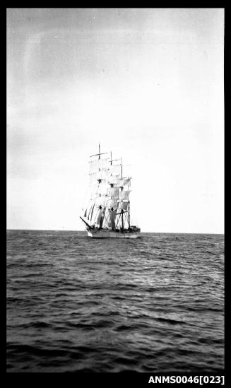 Four masted barque setting or reducing sail