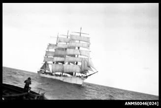 Four masted barque setting or reducing sail