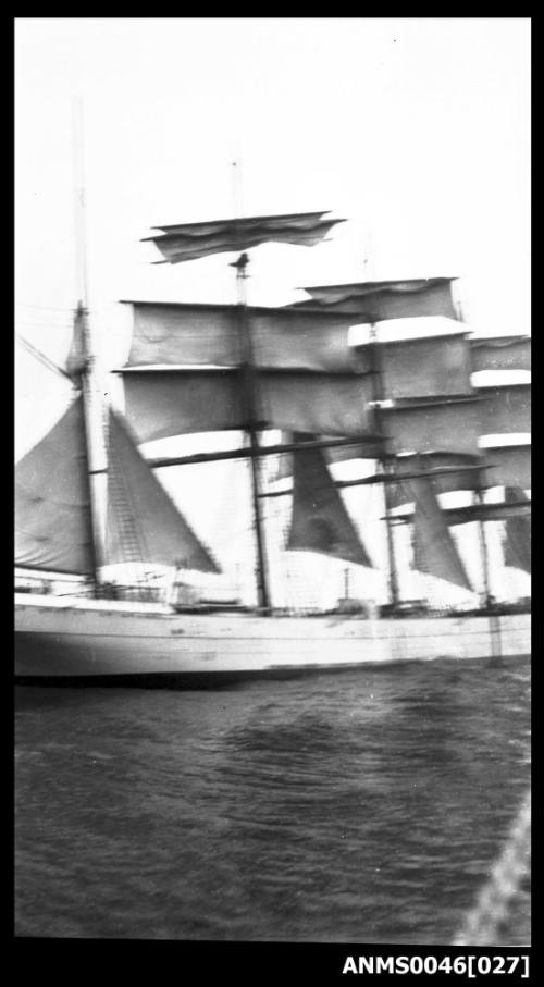 Four masted barque setting or reducing sail