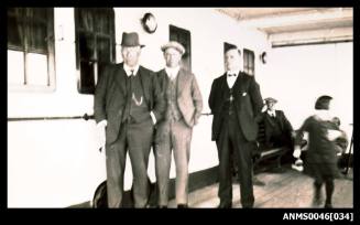 Three men in suits facing the camera