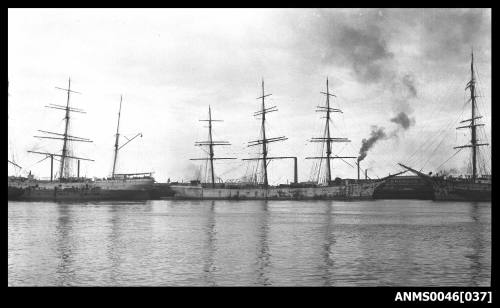 Three masted fully rigged ship alongside wharf