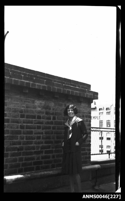 Young lady standing on rooftop or bridge