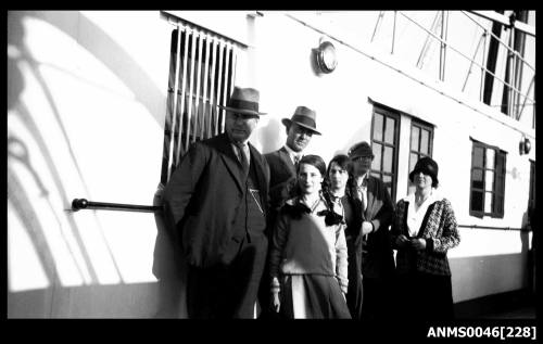 Group of people standing on the deck of a ship