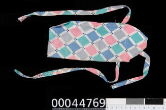 Doll's apron prop used by Lois Carrington