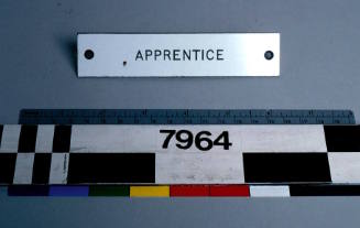 Plastic label sign from MV NANCY HEATH reading 'APPRENTICE'.