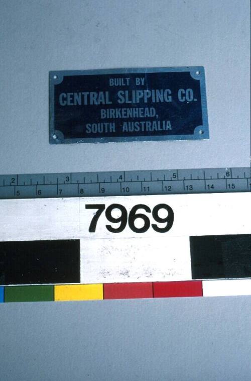 Blue metal sign with silver inscription reading 'BUILT BY CENTRAL SLIPPING CO BIRKENHEAD SOUTH AUSTRALIA'.